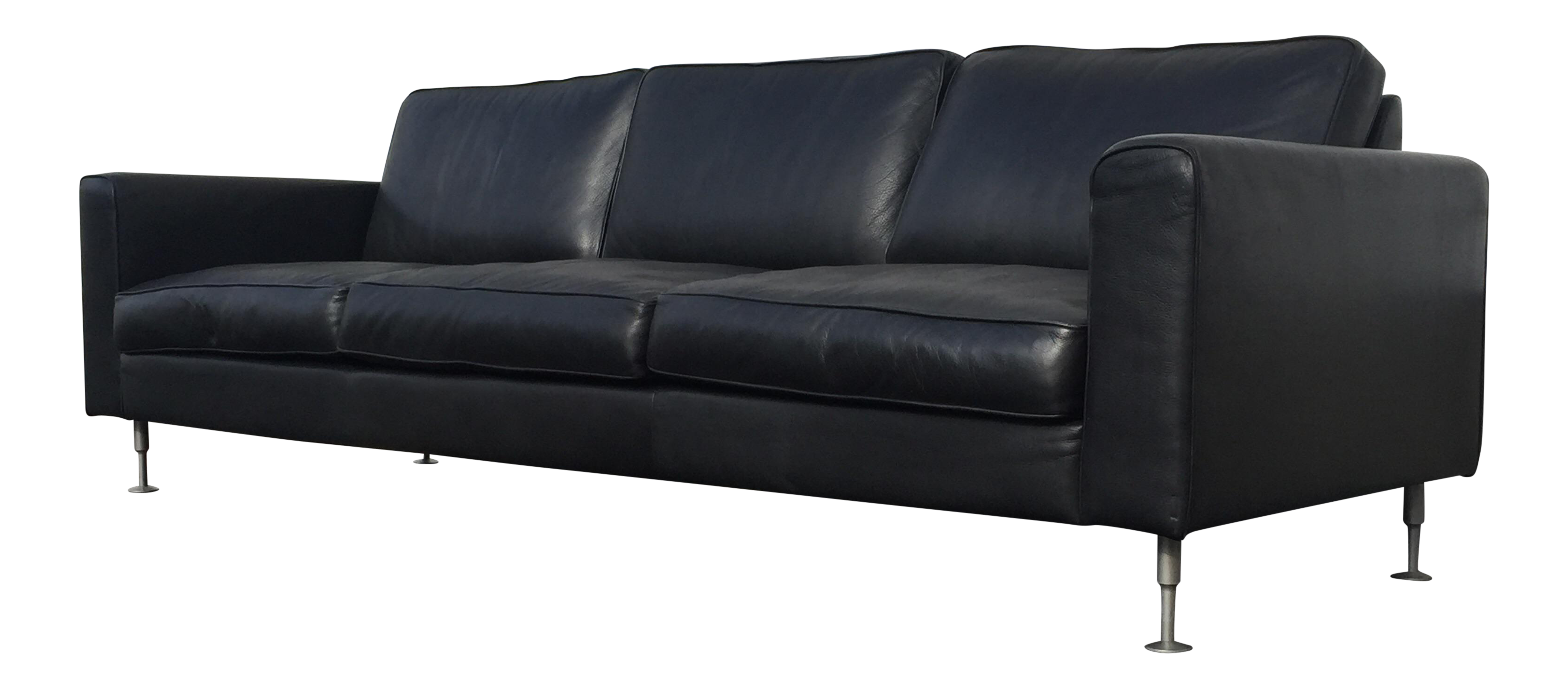 black leather sofa with fabric cushions