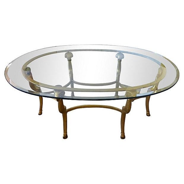 Gold Metal & Glass Oval Coffee Table | Chairish It makes the perfect perch for decorative serving trays or even board games for game nights with friends and family.
